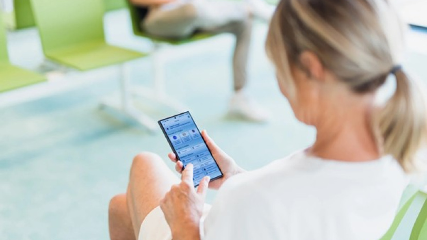 Vrouw bekijkt de app MyNexuzHealth op smartphone